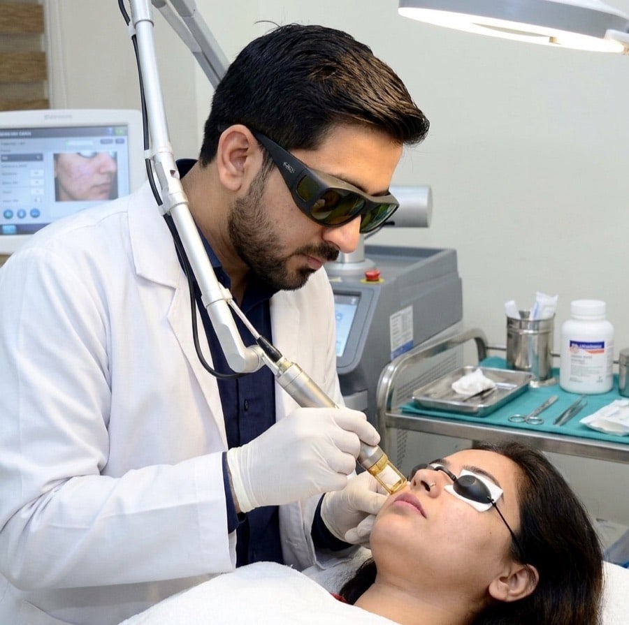 Dr. Raghvendra Pratap Singh performing a Q-Switched laser procedure on a patient at MySkin Clinic, Orai
